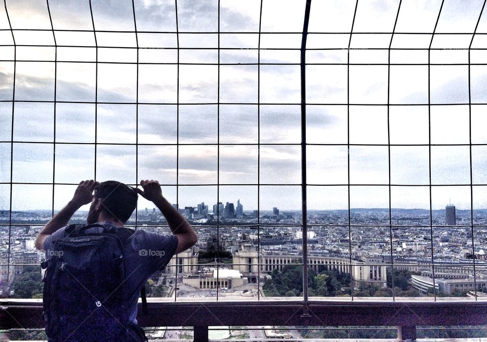 from Eiffel Tower second floor. traveler looking at paris from the second floor of Eiffel Tower 