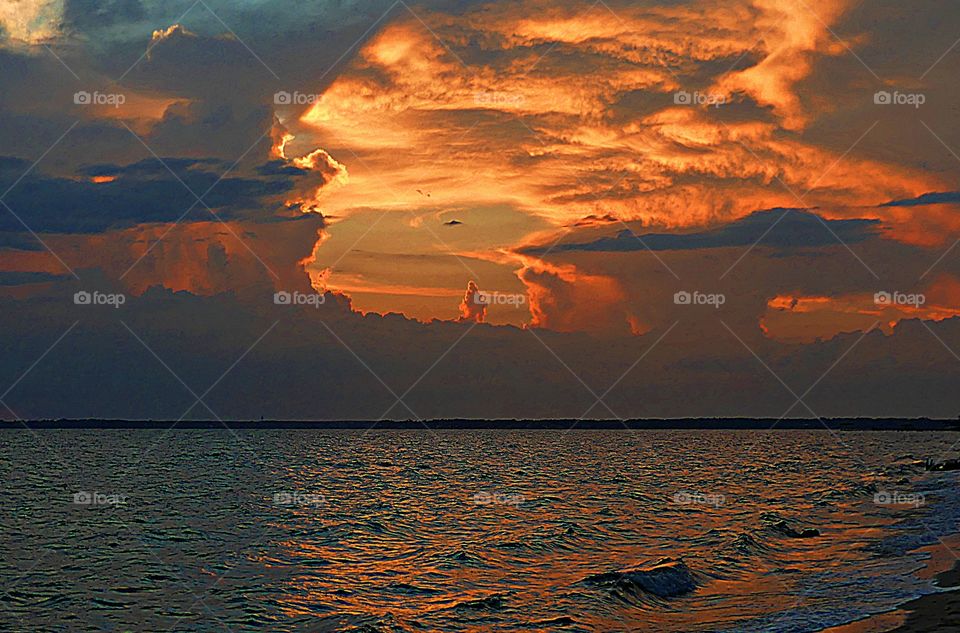 Sunrise, sunset and the moon - The golden sunset looks like a volcanic eruption captured with in the storm clouds