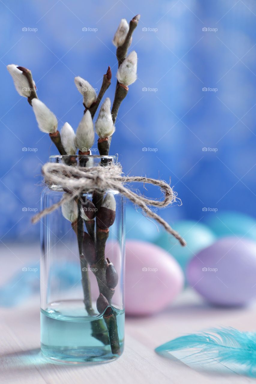 Easter eggs and willow branches in a vase