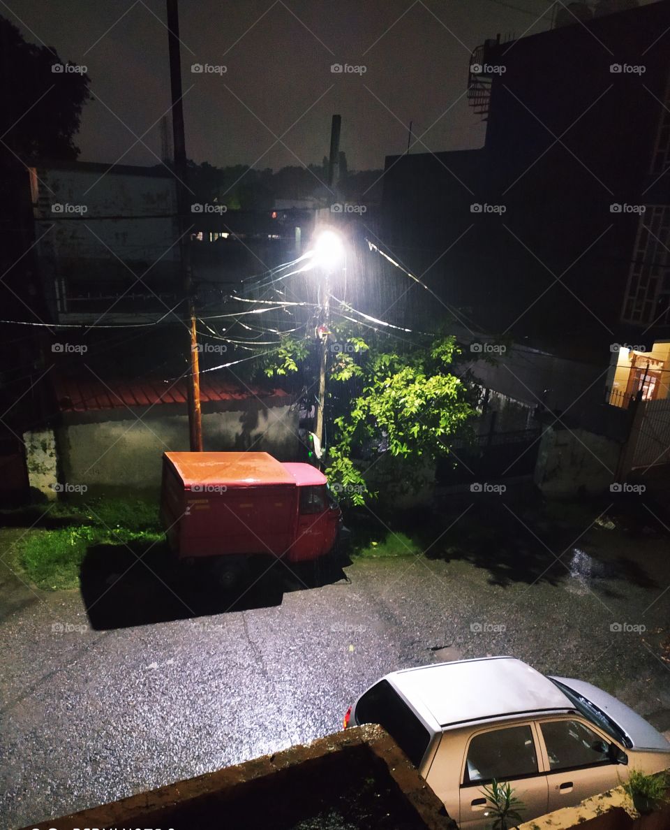 Dark sky, streetlight and heavy drizzles creating wonder in the night