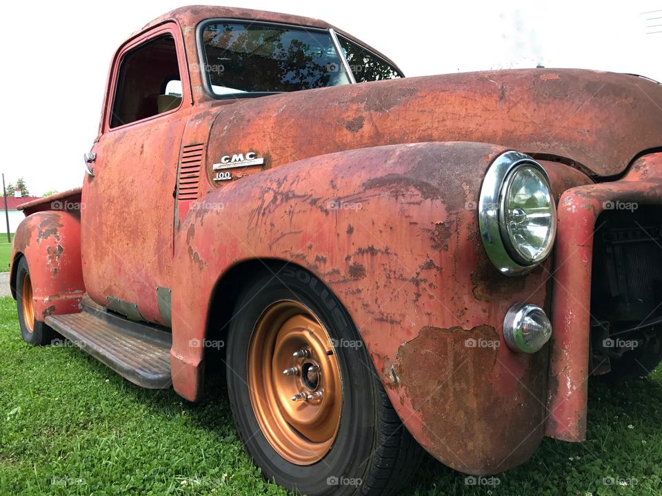 Rusted old 1960
GMC pickup truck with copper wheels