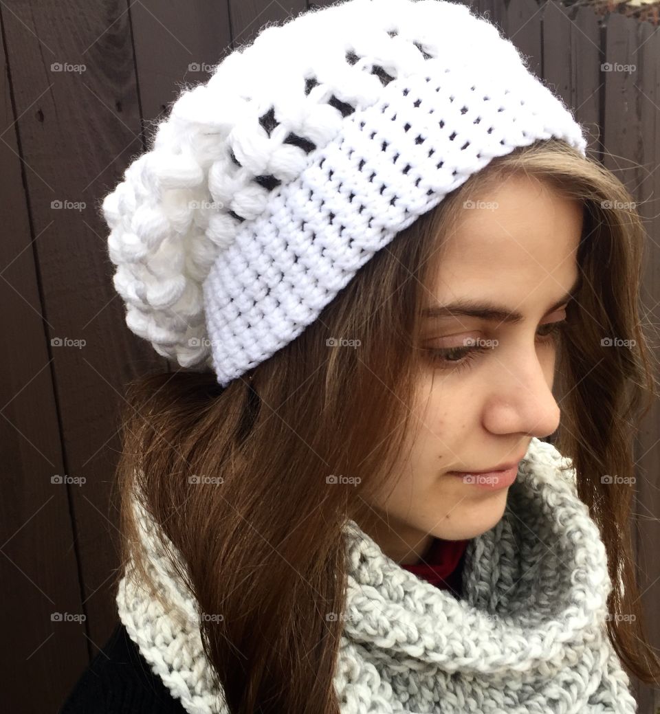 Woman holding woolen white hat