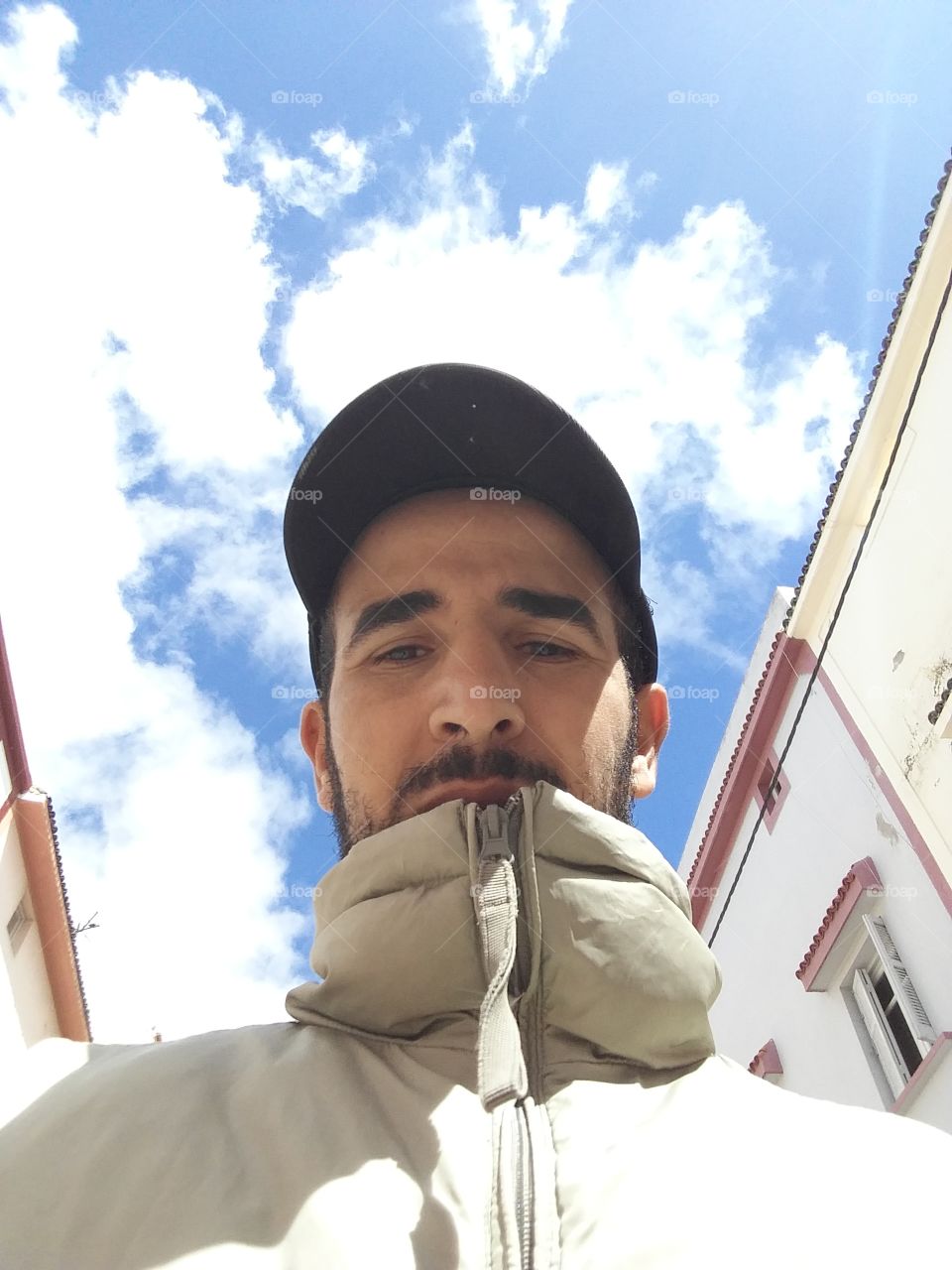 Low angle view of a man wearing cap