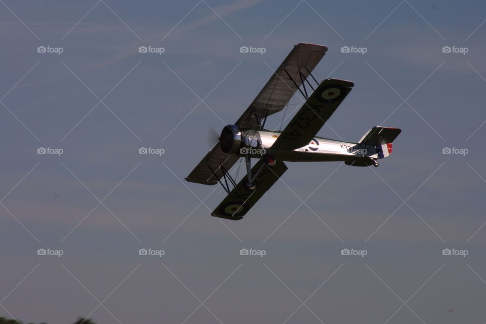 Vintage biplane aircraft airplane flying blurred propeller 