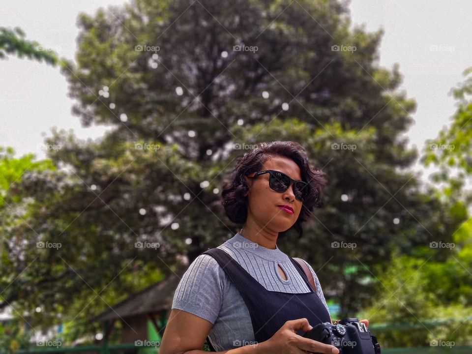 a woman holding a camera.