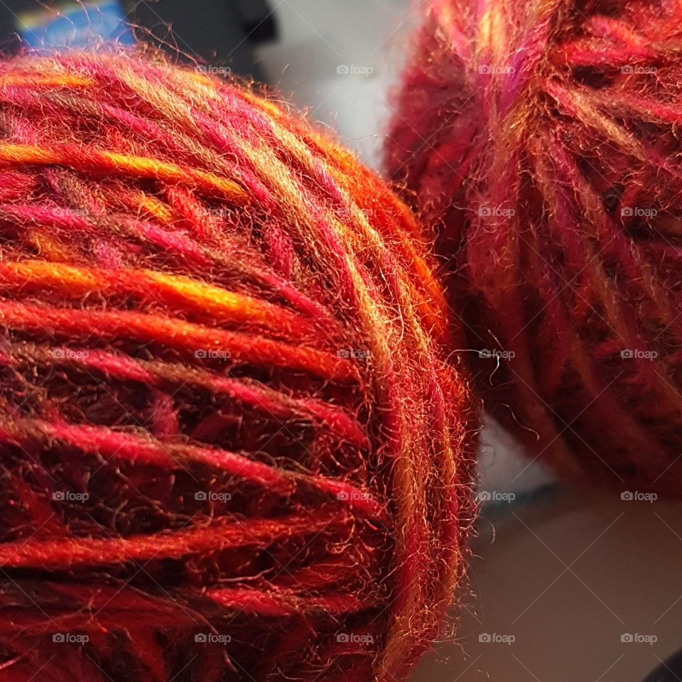 two reddish-orange balls of yarn