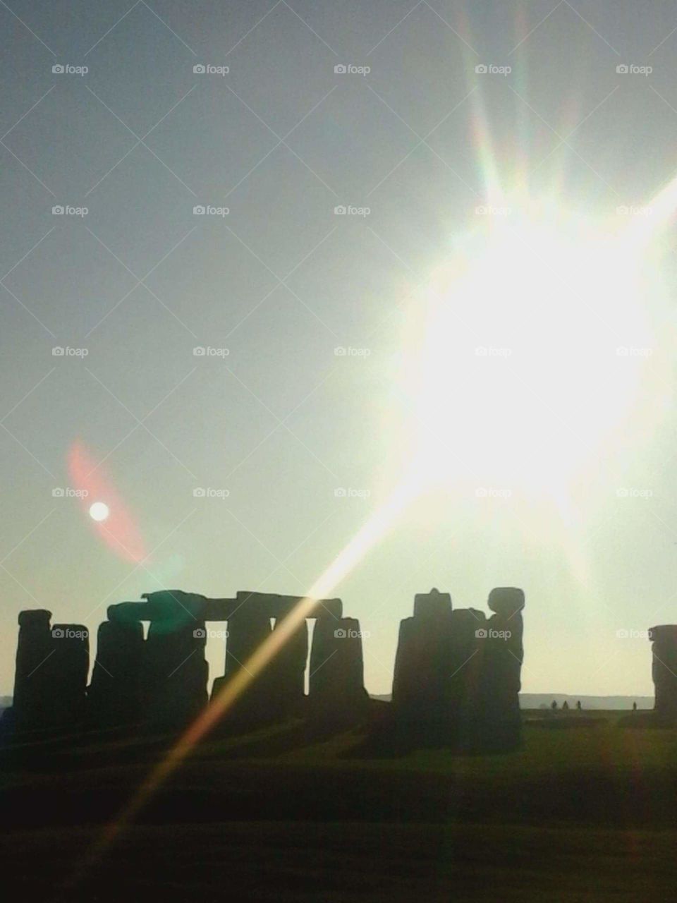 sun and moon over Stonehenge