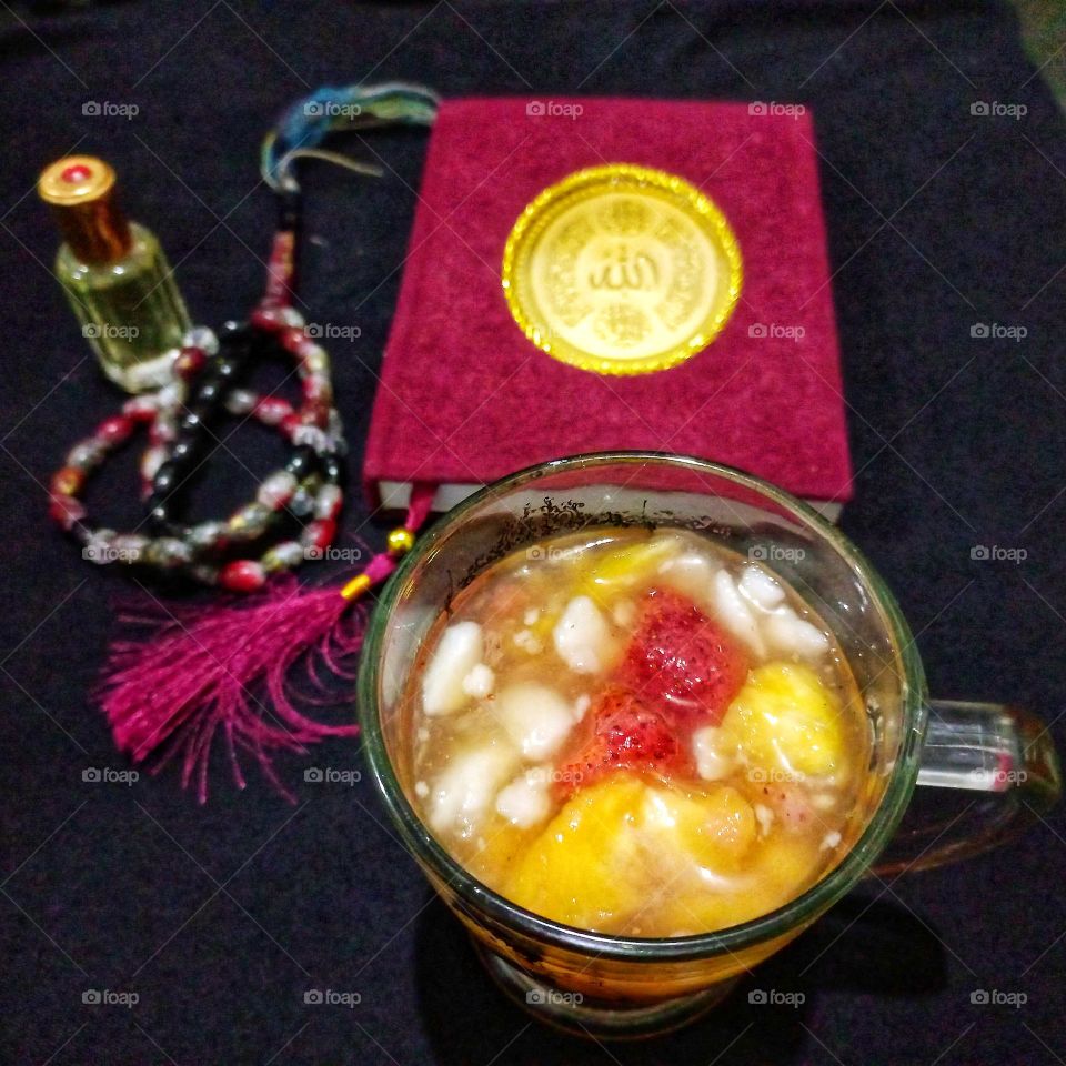 A glass of fruit drink (dinghy) for starters and fragrant prayer beads and the Holy Bible