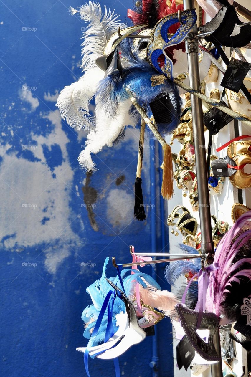 Venetian masks displayed on a stand in Venice, Italian carnival, Italian masquerade, carnival costumes 