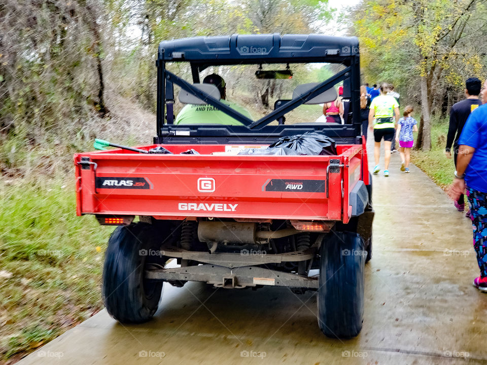 Red Gravely AWD  Jobsite vehicle on a cement park path with walkers