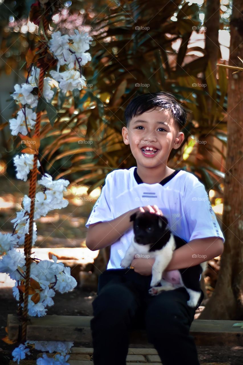 Young kid holding a puppy
