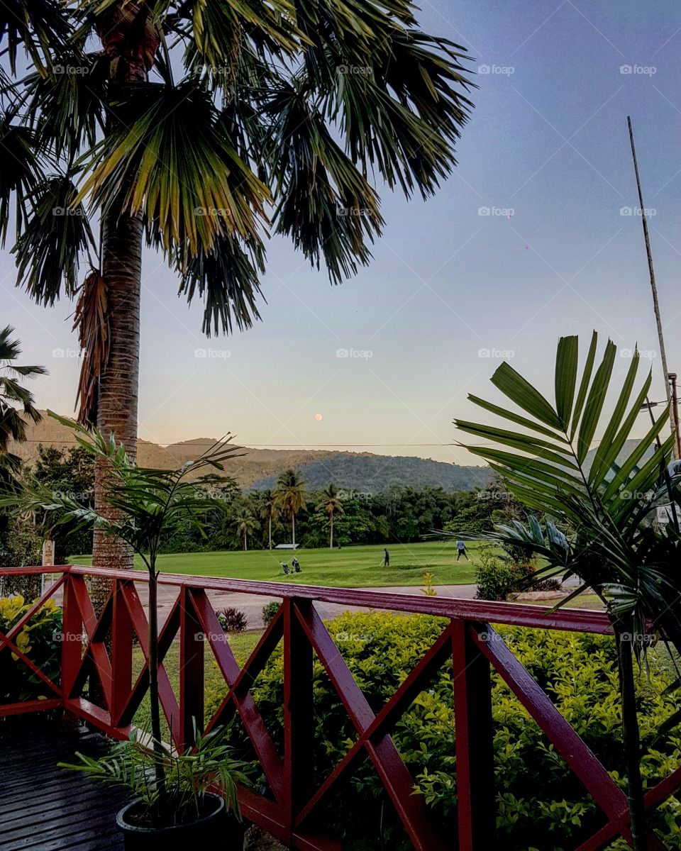 Day-moon over the golf corse