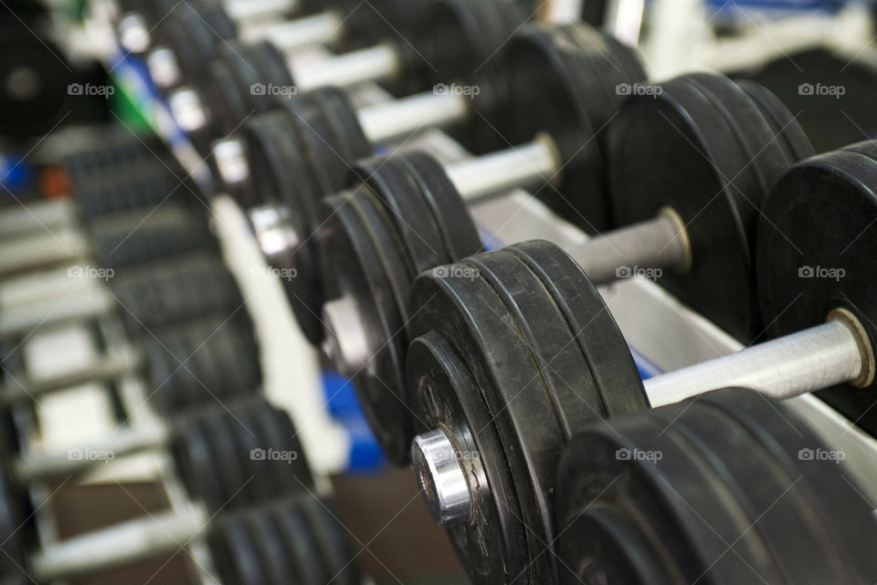 Rows of dumbbells in the gym. Dumbbells on the rack in the sports hall of the club