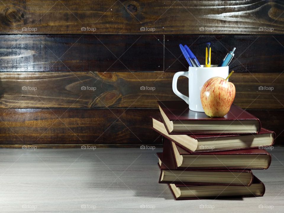 books, pen and apple on wooden table. study concept. Teacher's Day. student day. knowledge and reading.
