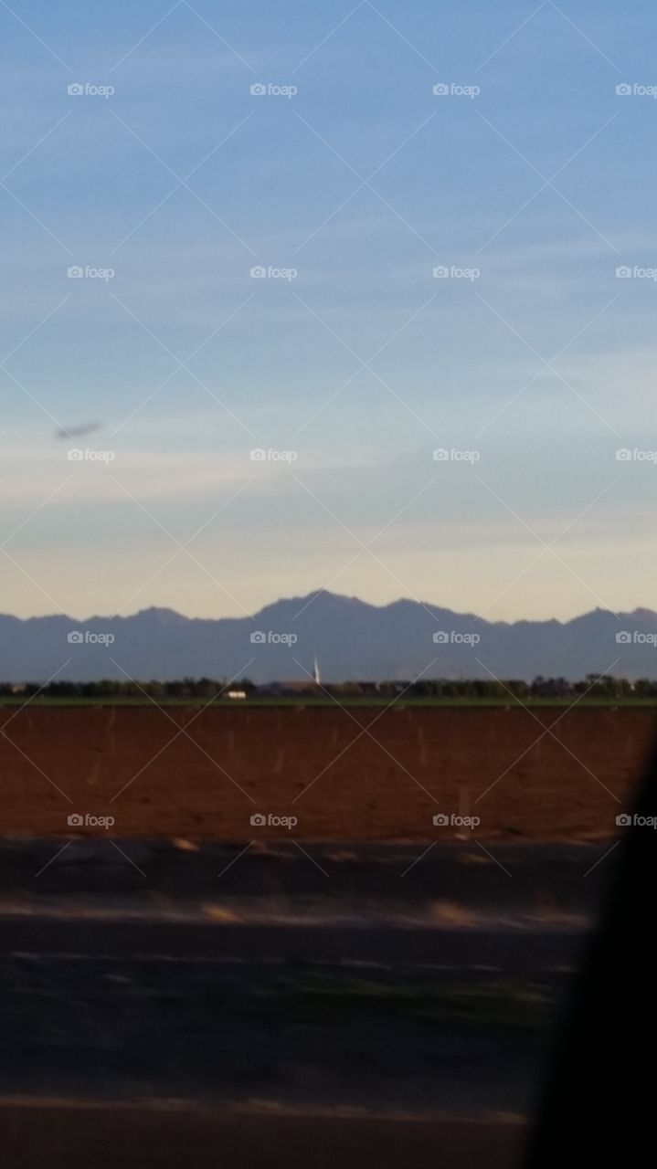 Estrella Mountain Range
Taken thru a car window
With a crop in front 
i guess one does what one can .
When your in a carseat ...traveling..
At a 35 mile an hour speed... 
Hey ...i liked what i seen
Thought ... why not share.... 
A mountain range ..