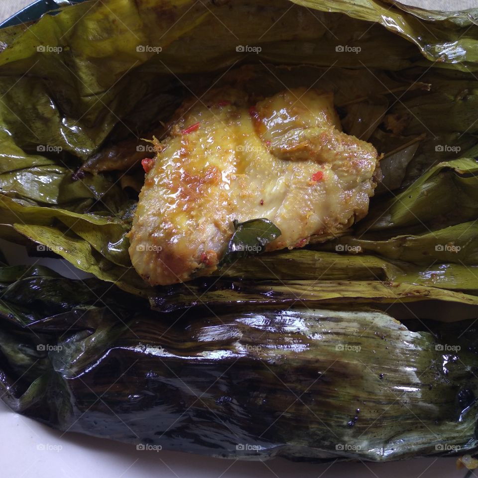 Steamed chicken wrapped in banana leaves