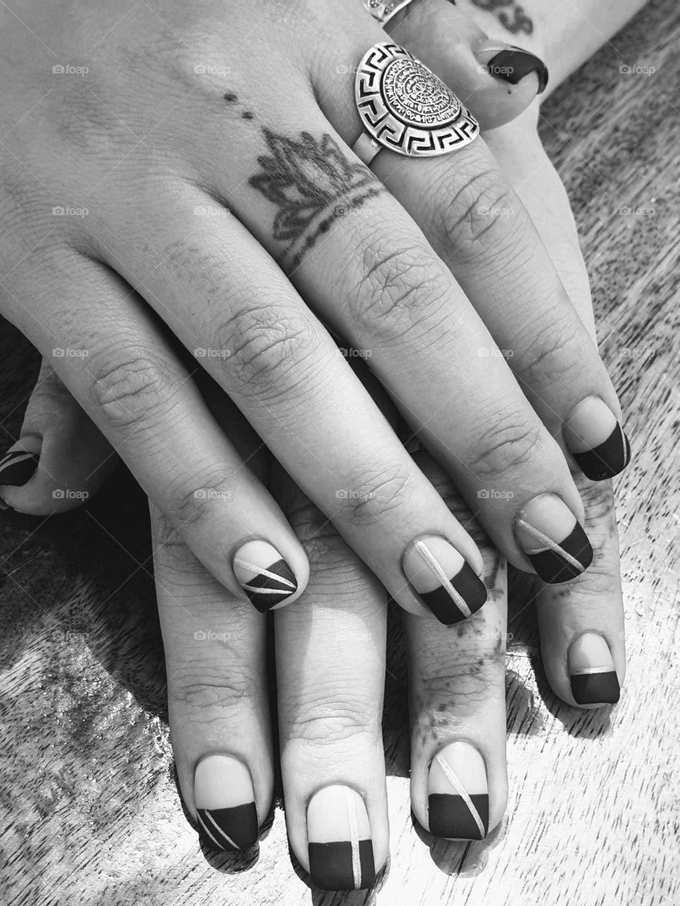 Tattood hands of a coffe table