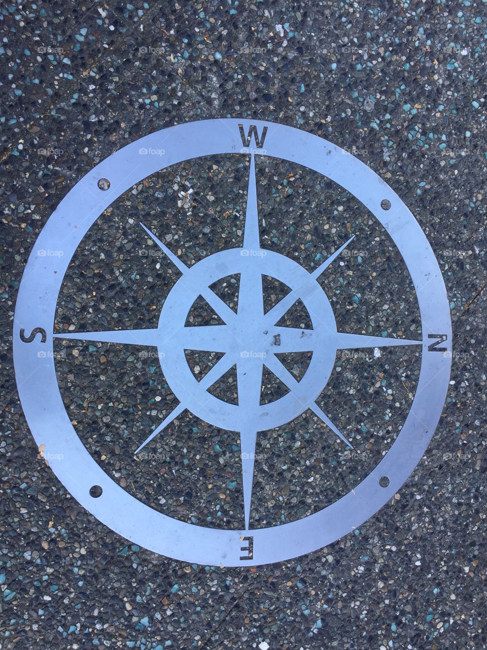 Compass on sidewalk 