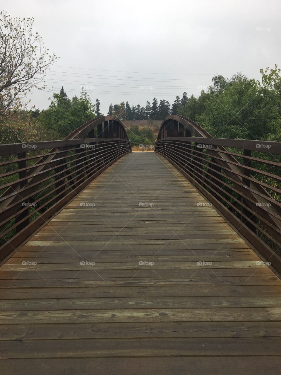 Morning gray clouds and an old brown wooden bridge