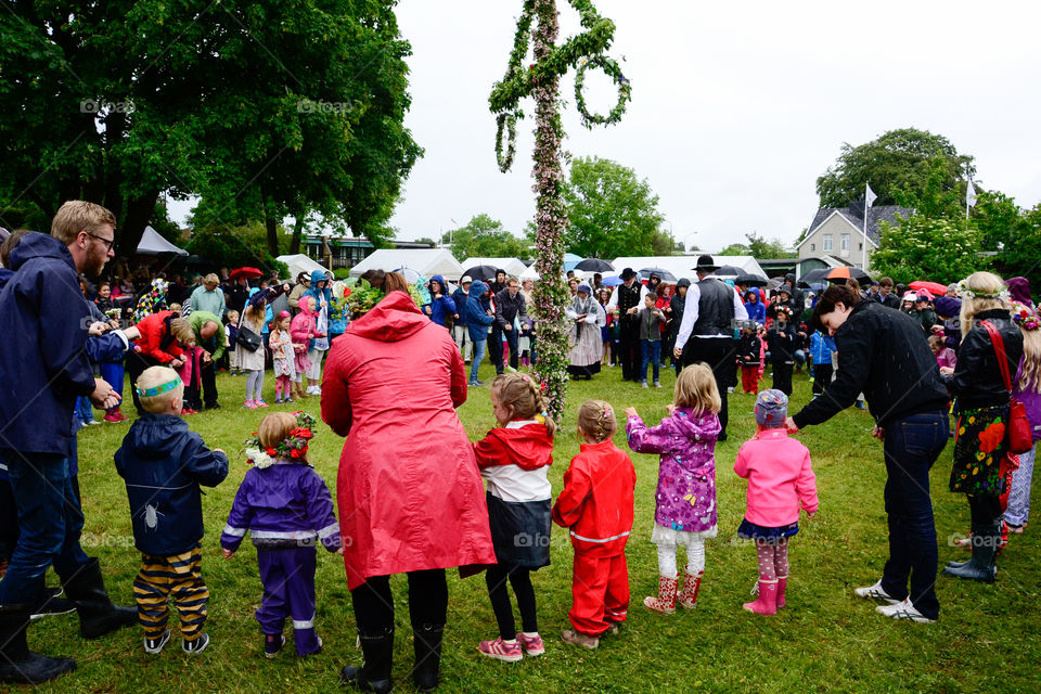 Swedish people is celebrating midsummer in the rain.