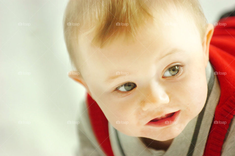 CLOSE UP OF BABY BOY LOOKING OUT OF THE FRAME TO THE RIGHT