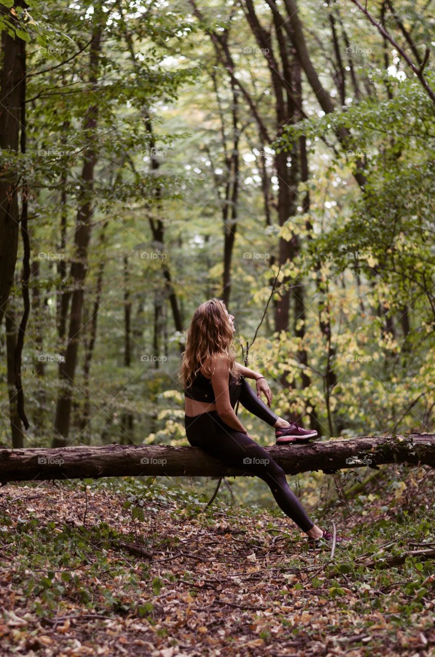 Young blonde woman relaxing in the forest