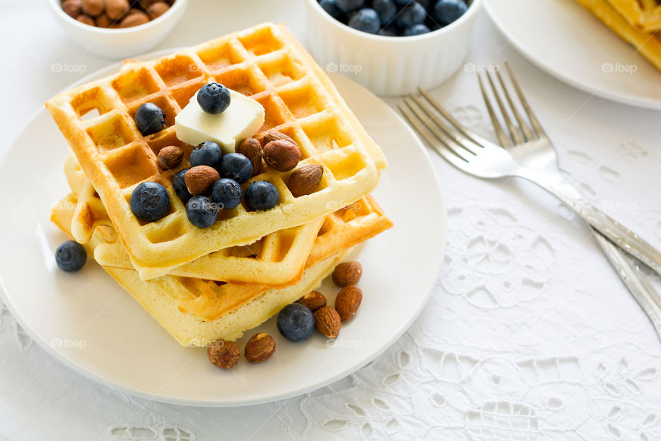 Belgian waffles with butter, blueberry and nuts