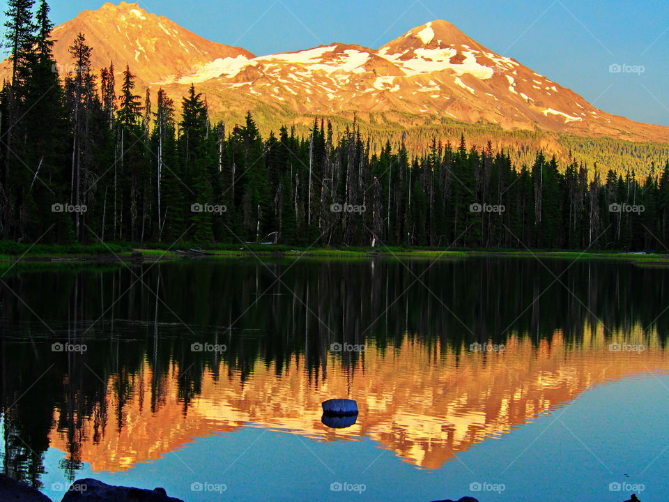 Mountains and trees reflecting on the lake