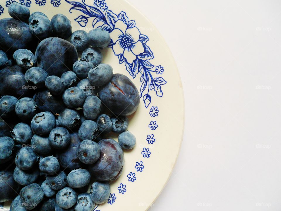 blueberries and plums on a plate