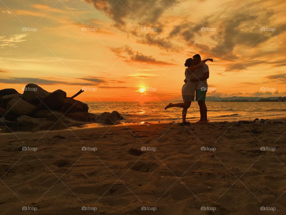 Couple on the beach at sunset