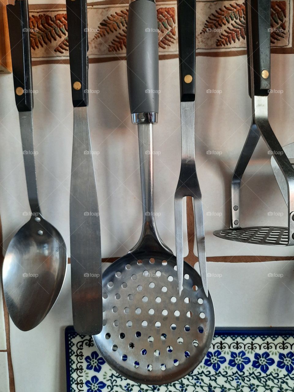 metal kitchen cutlery hanging above the stove