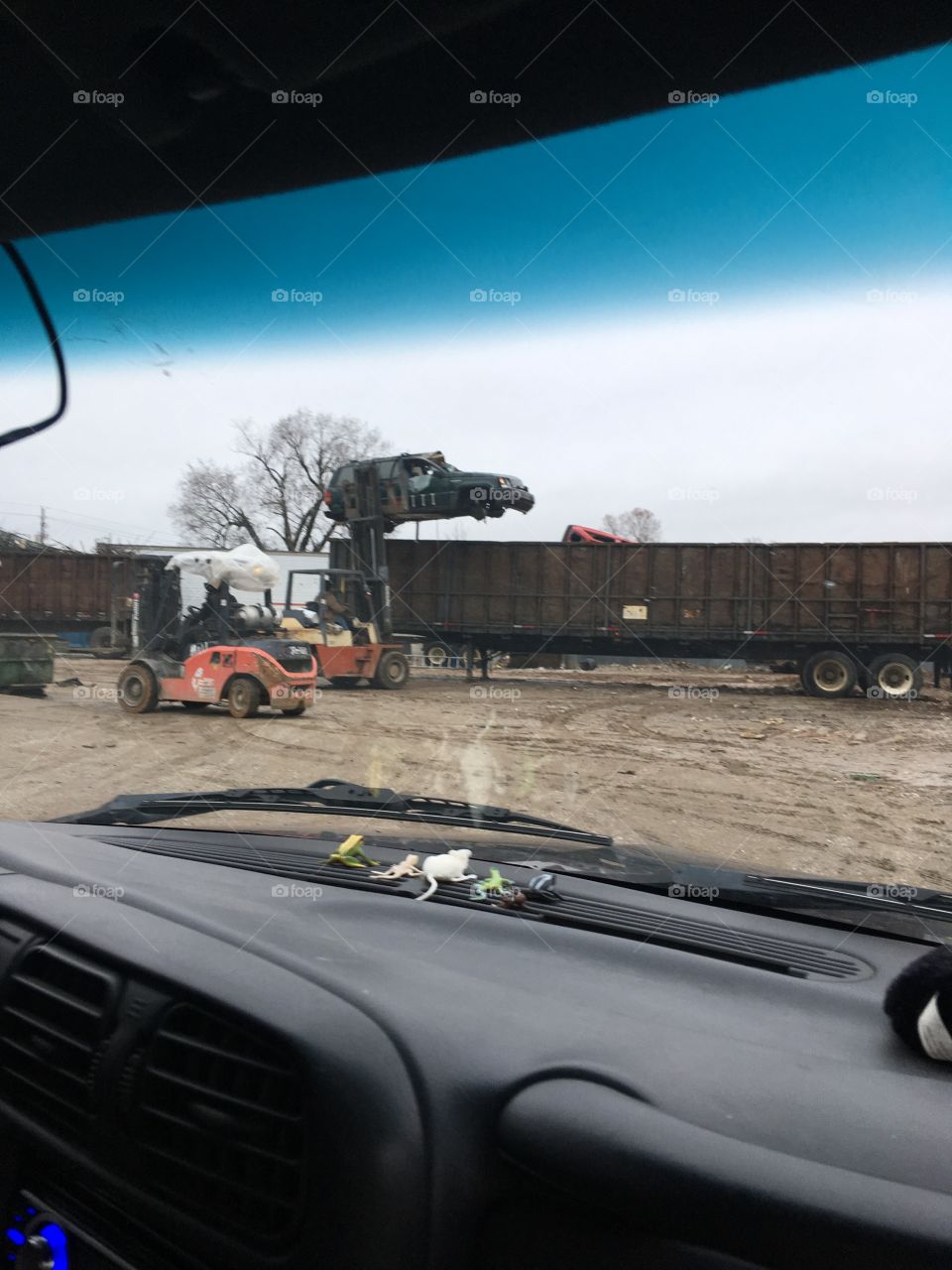 Jeep Cherokee being lifted up into the trailer at the recycling place clean up time!