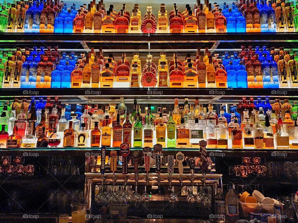 A well stocked bar provides thirsty patrons with the alcohol of their desires as well as a beautifully colored focal point