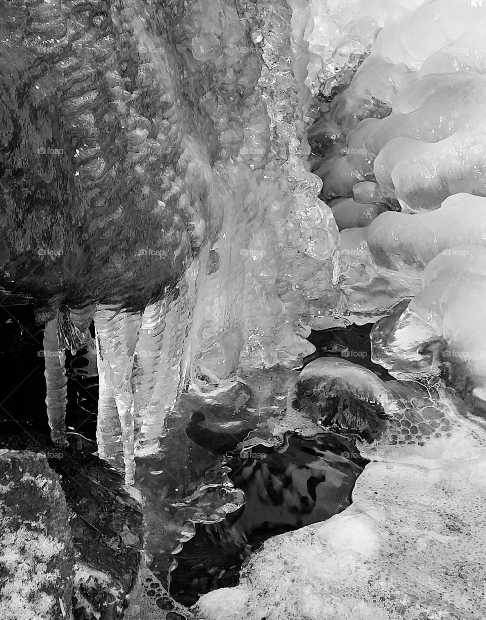 Frozen water by a waterfall closeup