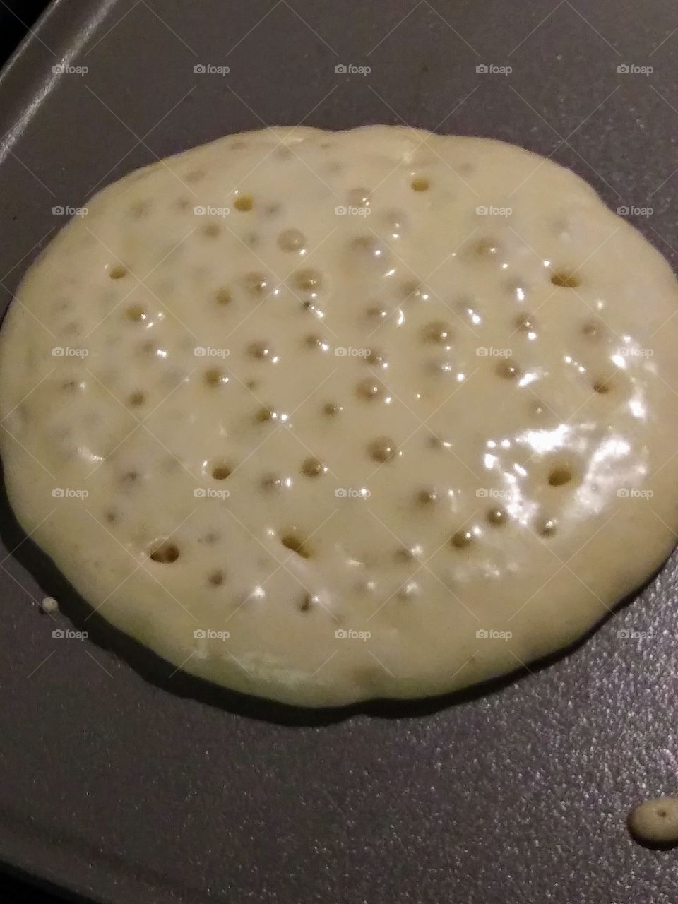 bubble on the uncooked side of a pancake