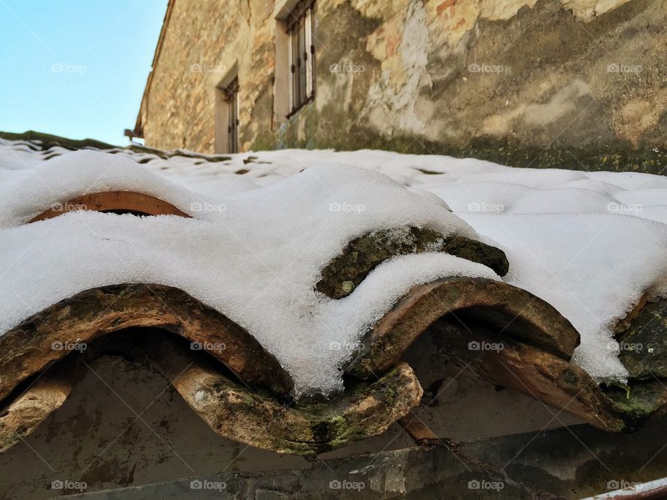 Winter view over a snow covered roof