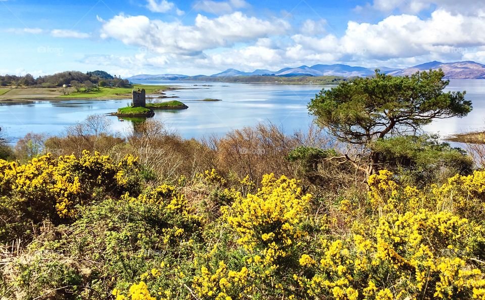 The mysterious and unique Castle Stalker in the middle of the lake in the Scottish Highlands