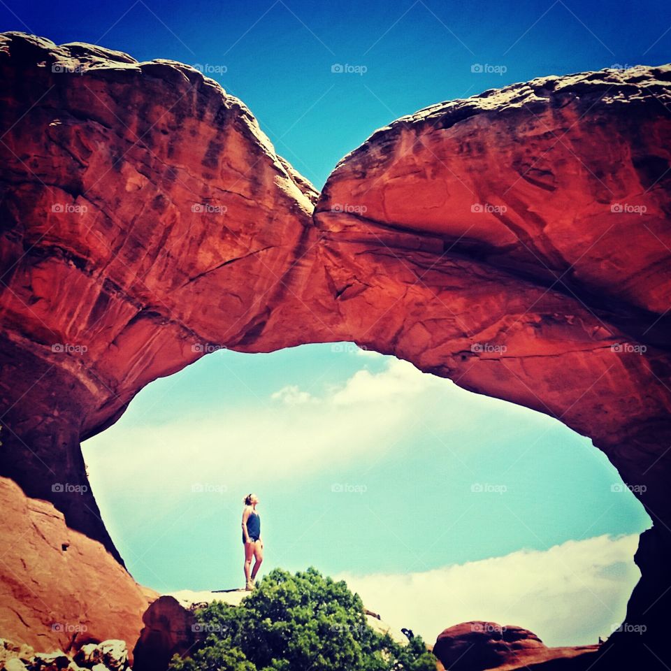 Girl under arch at Arches national park Utah