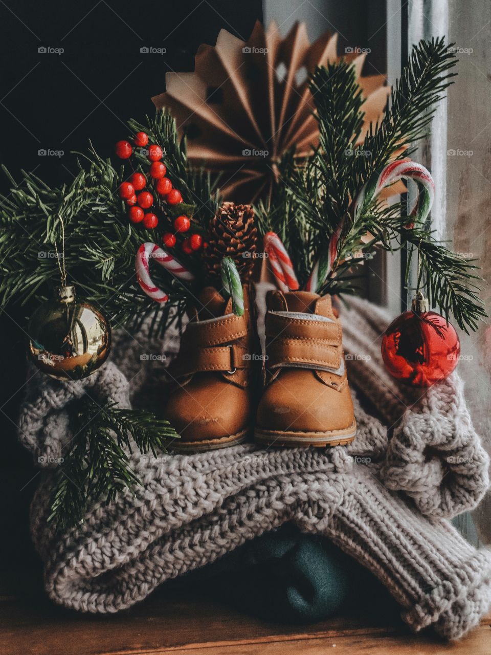 still life with fir branches in children's boots