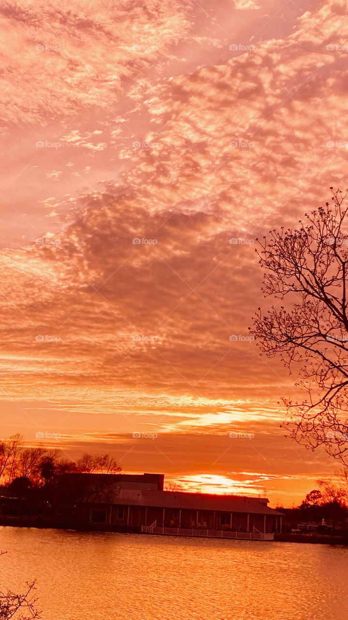 Leading Edge of Cloud Mass meeting up with Setting Sun Creating a huge Orange Whispering Leading Edge Clouds. 