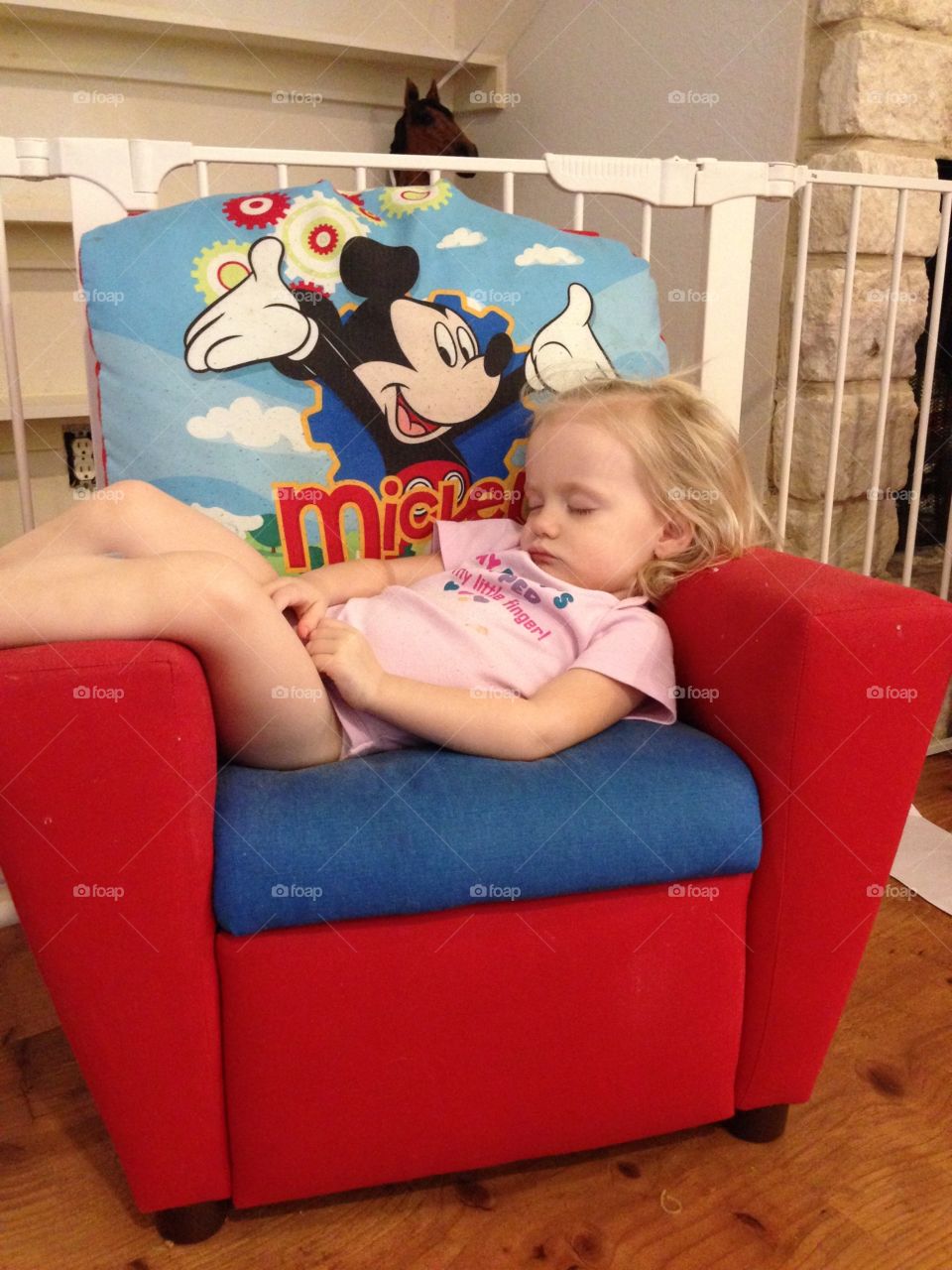 Toddler girl sleeping in a child recliner