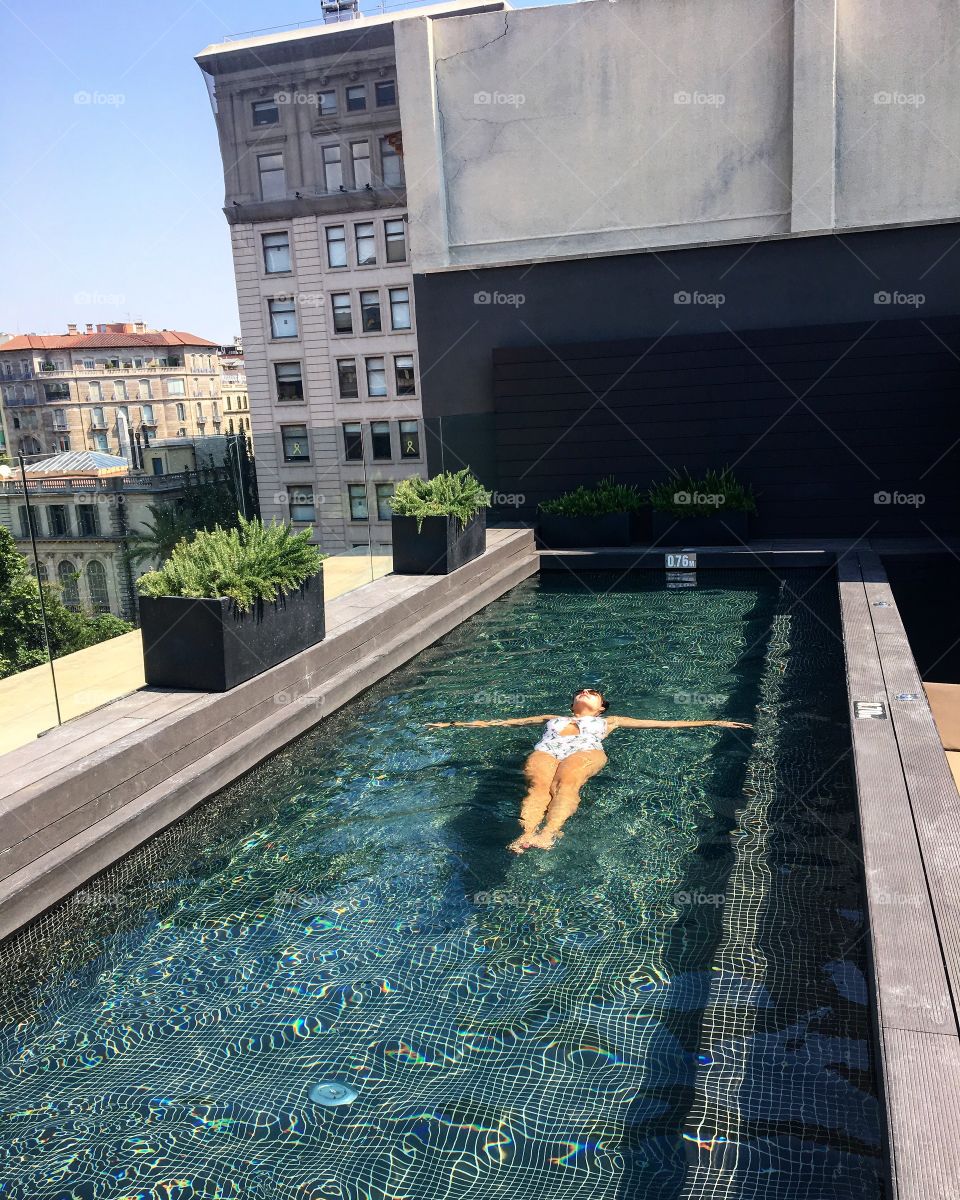 A summer day in the swimming pool on the top of my building. A beautiful terrace with lots of views of The city.  