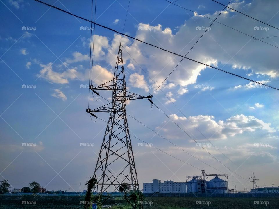 Electric Transmission Pole / Electricity / energy / cloudy weather / industries / farm / blue sky / wires