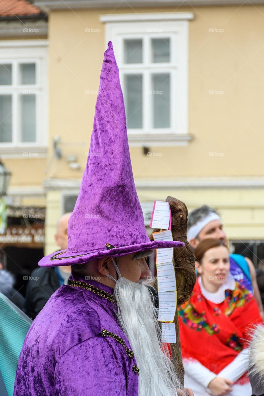 Side view of man wearing purple wizard costume at carnival