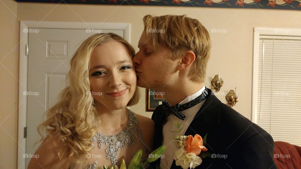 A kiss and a smile. My son and his girlfriend getting ready to leave for his senior prom.