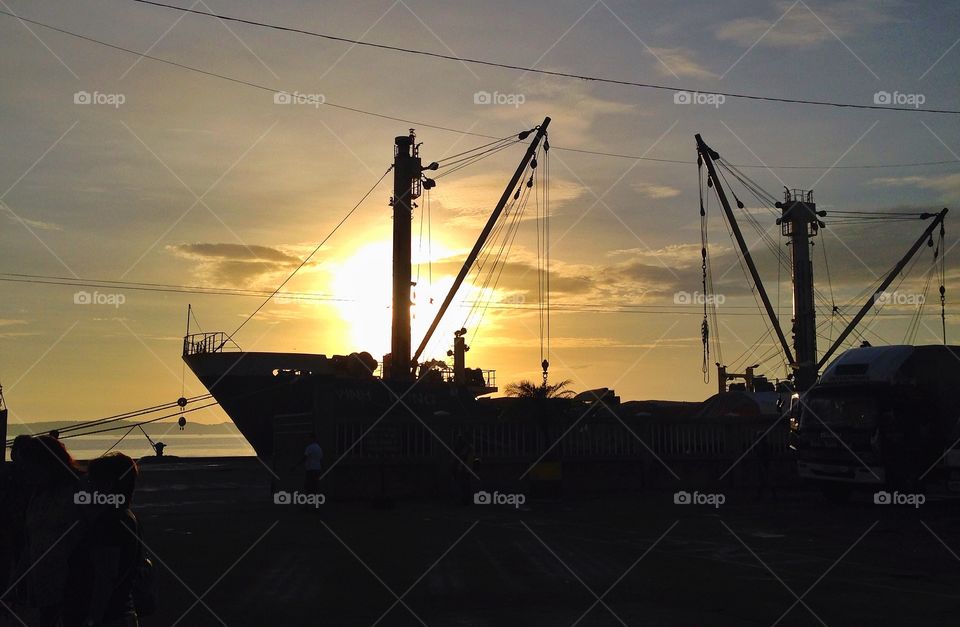 This cargo ship is by the port waiting to be filled with all its load before it goes. 