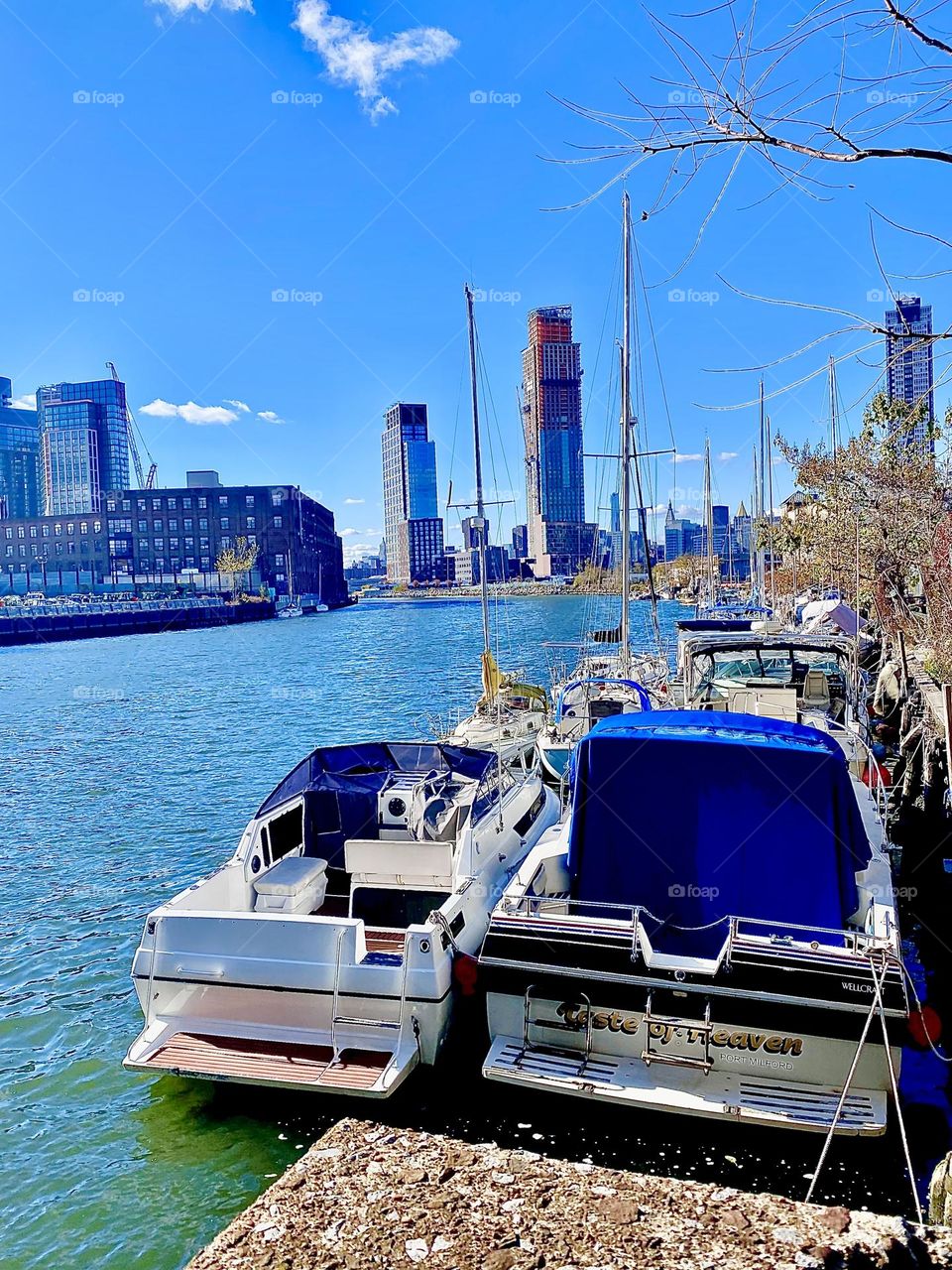 Boats in the waters of the East River at Newtown Creek in LIC, Queens, NY photographed on a sunny afternoon in the Fall of 2021. Hypnotic Productions