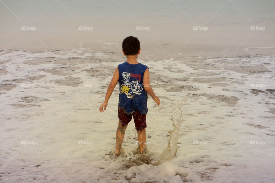 A boy playing at the beach