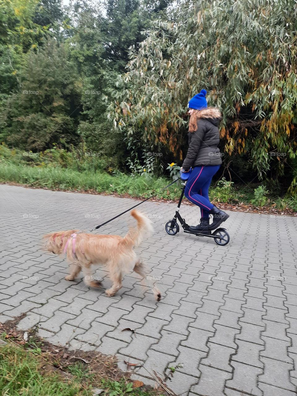 girl on scooter and her dog at demiseason