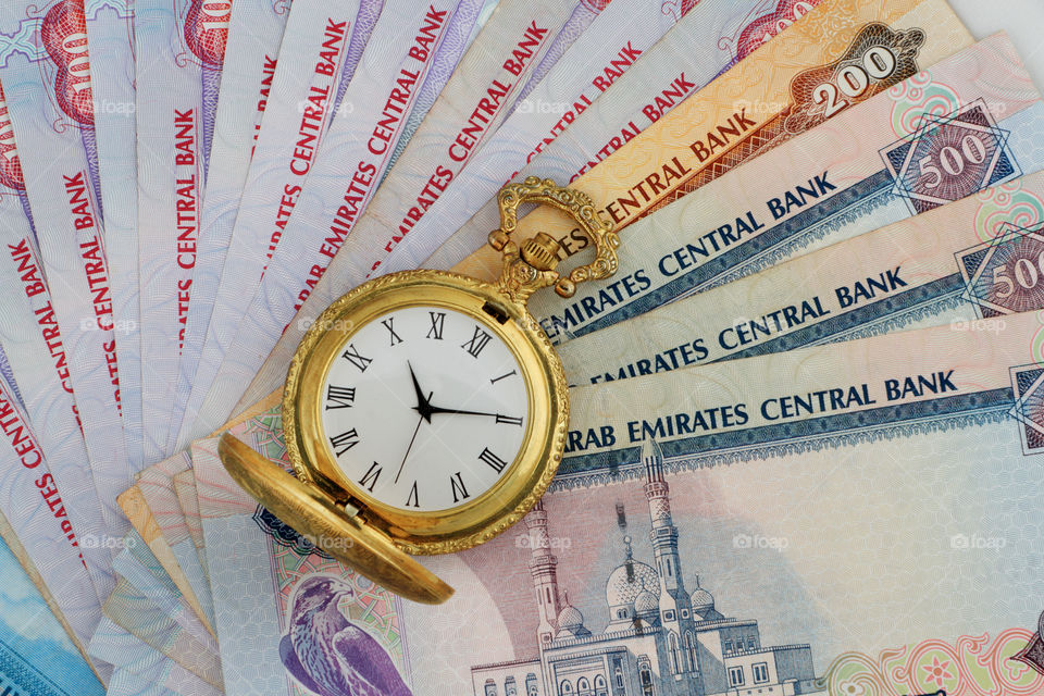 Antique watch on uae dirham money currency concept